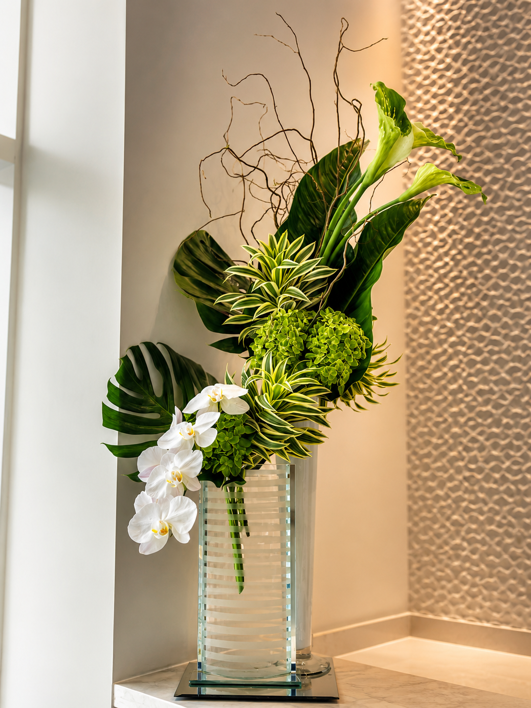 Tall green and white botanical arrangement in a luxury interior